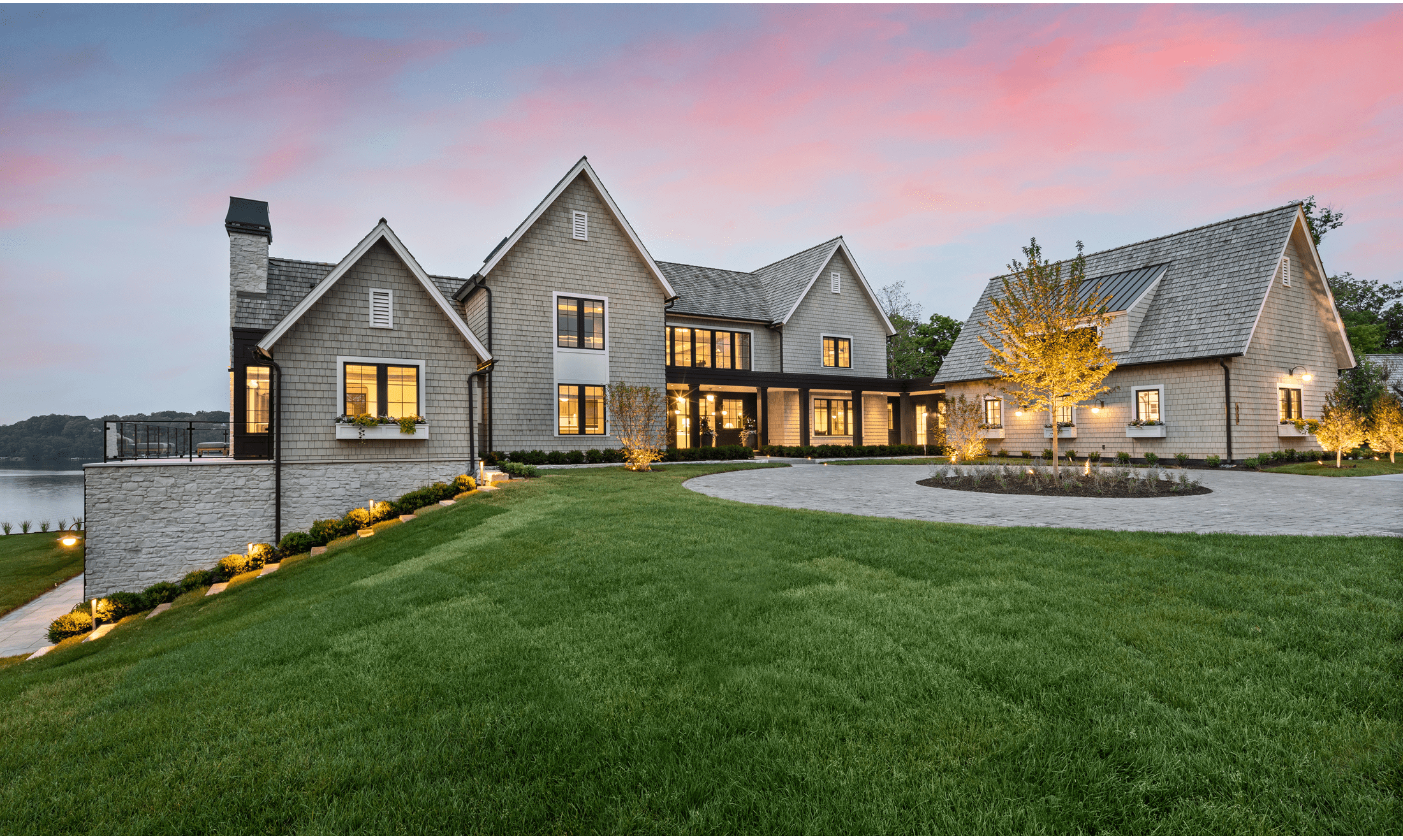 The outside front door and driveway of the large, luxury home designed by PKA Architecture from Minneapolis, Minnesota.