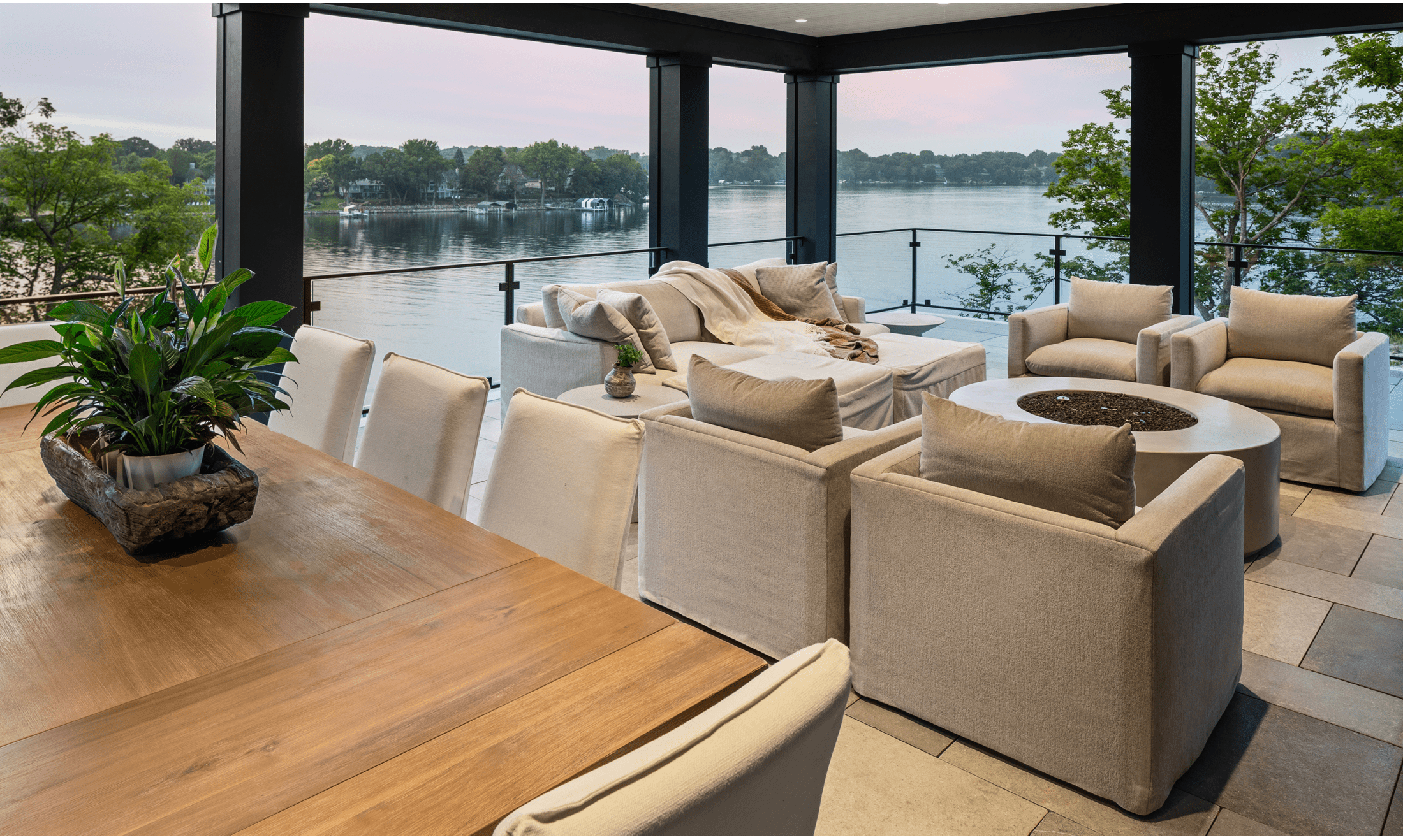 The enclosed patio helps connect the exterior with the interior with numerous seating areas, a fireplace, and dining table.