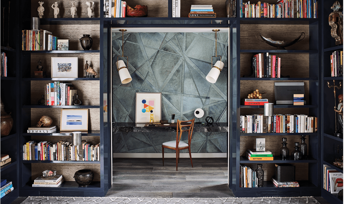 A custom interior collaboration with Jeffers Design Group highlighting an exceptional workspace hidden within shelves.