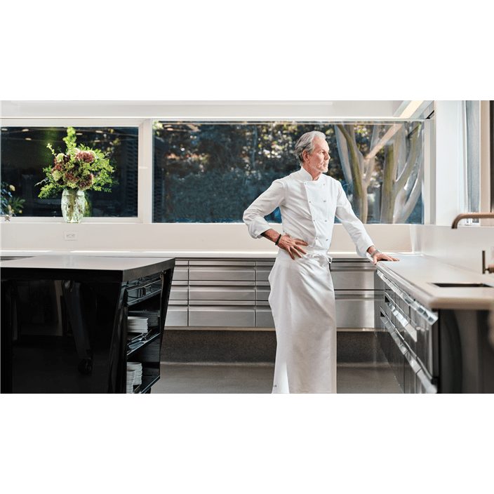 The kitchen of The French Laundry, designed to let in light from multiple windows, as Chef Keller poses contemplatively.