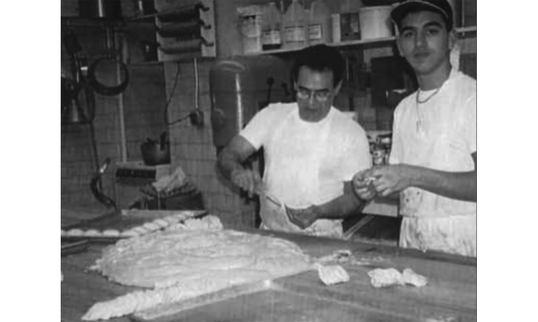 A young Valastro and his father working together at Carlo's Bakery. 