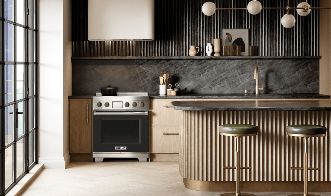 Sub-Zero, Wolf, and Cove's Professional Induction Range with black knobs and a black door in a luxury kitchen.