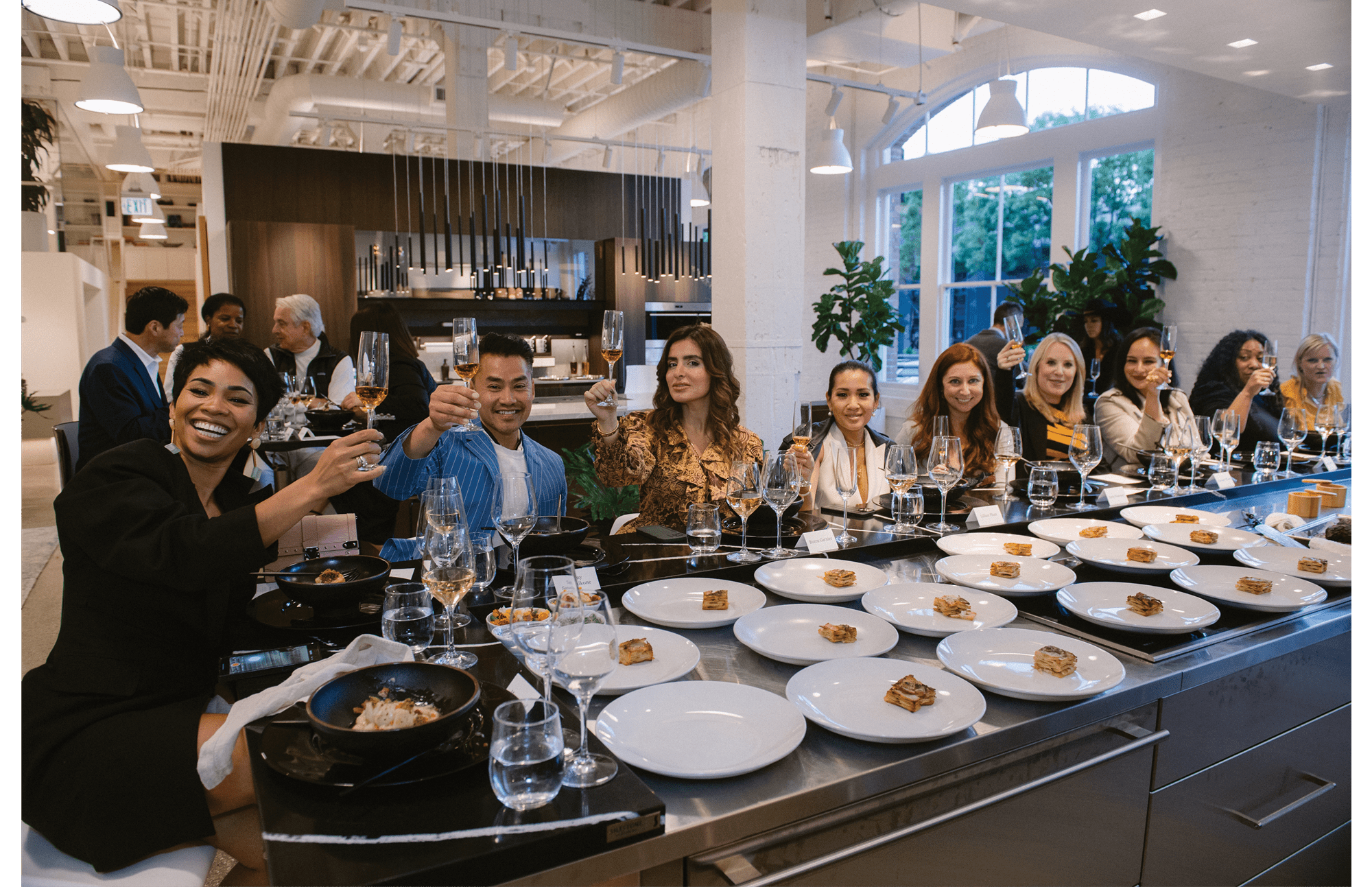 A group having dinner at the Riggs Showroom in San Francisco featuring exclusive Sub-Zero, Wolf, and Cove appliances.