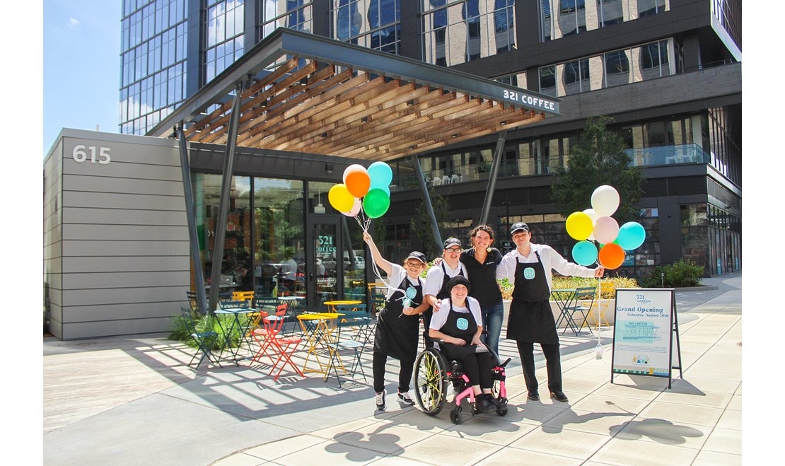 Lindsey Wrege joins some of the staff at the grand opening of 321 Coffee’s Downtown Raleigh location.