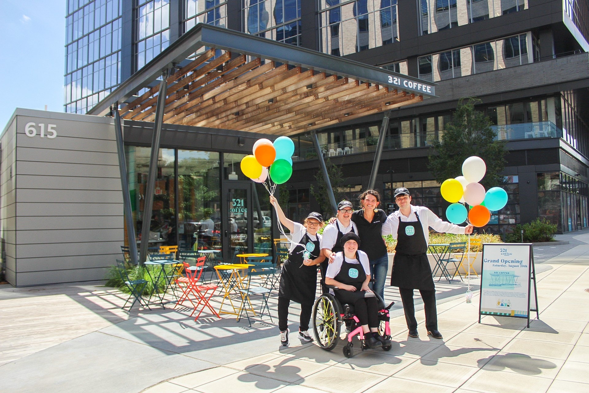 Lindsey Wrege joins some of the staff at the grand opening of 321 Coffee’s Downtown Raleigh location.