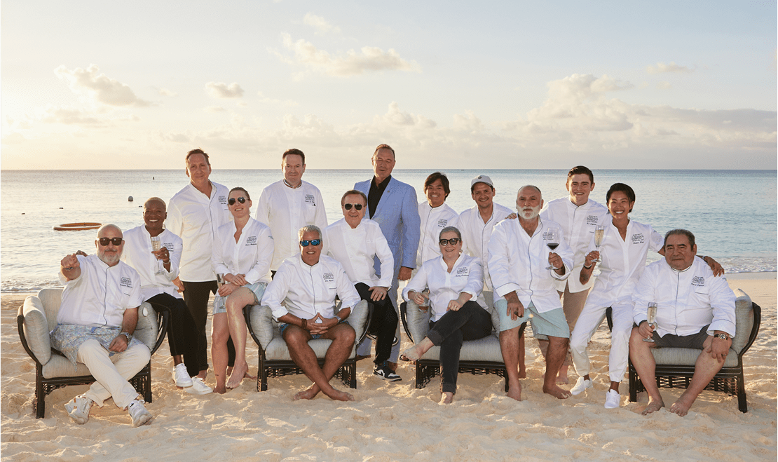 The chefs of the Cayman Cookout posed on the beach with the general manager of the Ritz-Carlton, Grand Cayman.