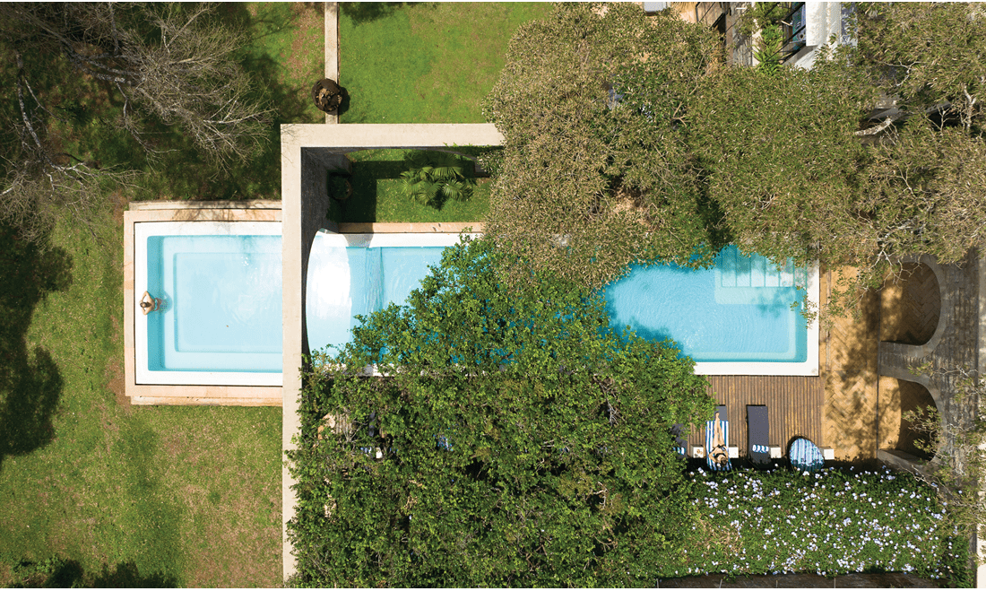 The infinity pool at the Giraffe Manor offers guests an opportunity to relax and interact with giraffes.