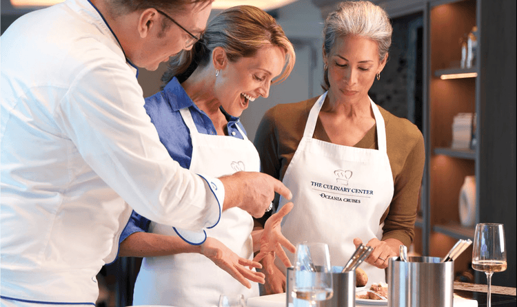 Aboard the Vista, Oceania Cruises offers hands-on cooking classes like this group being led by a chef.