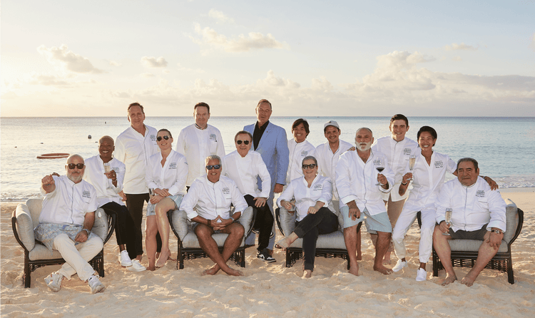The chefs of the Cayman Cookout posed on the beach with the general manager of the Ritz-Carlton, Grand Cayman.